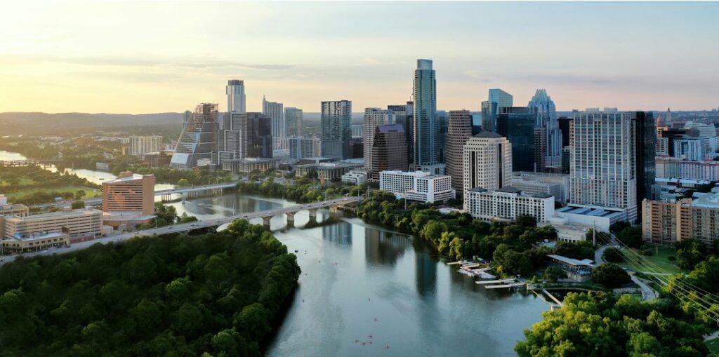 Aerial view of Lady Bird Lake and the downtown Austin skyline at sunrise