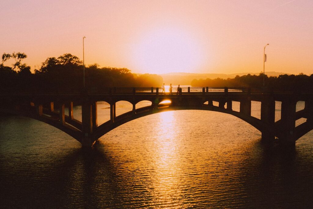People crossing a bridge over the Colorado River in Austin