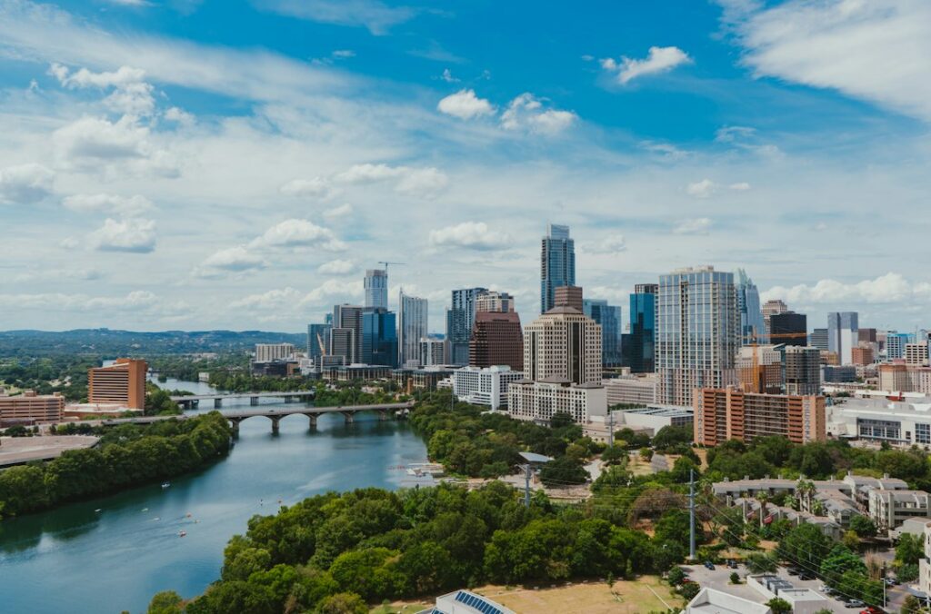 Downtown Austin office and apartment towers along Lady Bird Lake on a sunny day