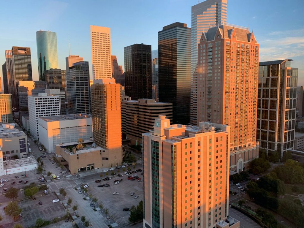 Houston skyscrapers lit by an orange sunset
