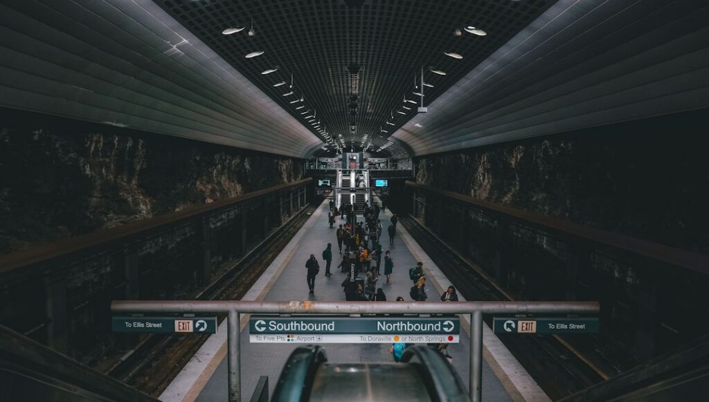 An underground rail station platform with escalators and northbound and southbound signs
