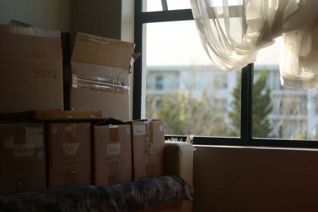 Packed moving boxes in an empty room