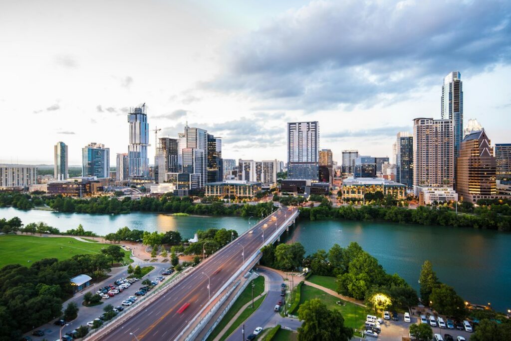 Traffic on a bridge crossing Lady Bird Lake toward the downtown Austin skyline