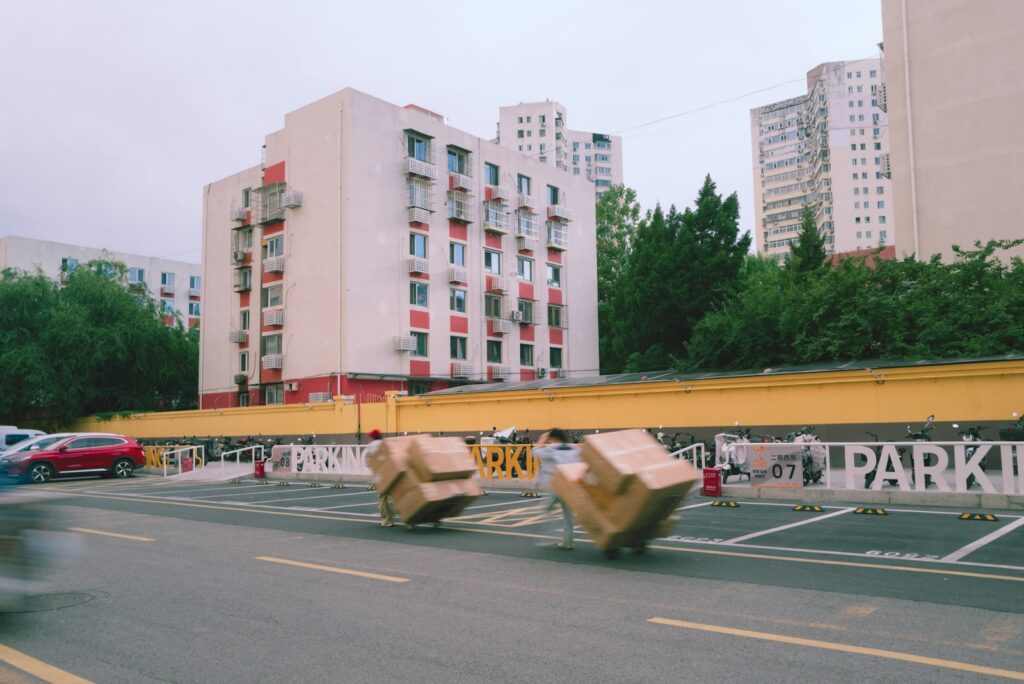 Moving boxes on a hand truck outside apartment buildings